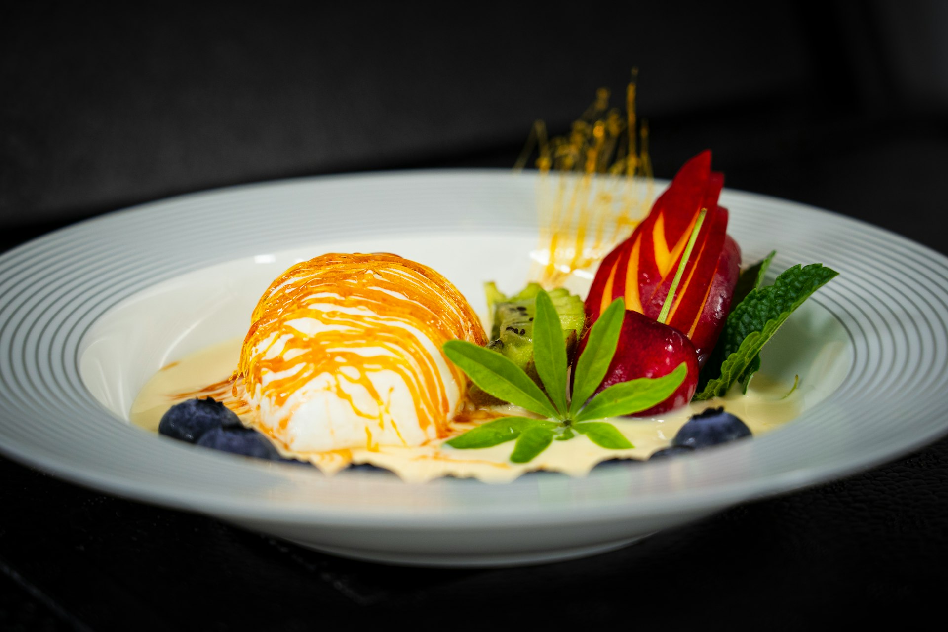 a white plate topped with fruit and ice cream